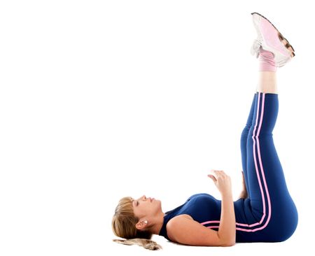 Girl exercising on the floor isolated over a white background