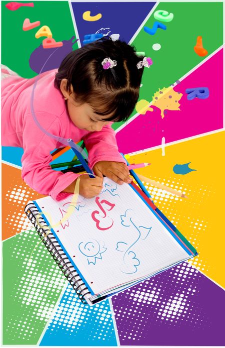 Little girl painting with colours in a notebook