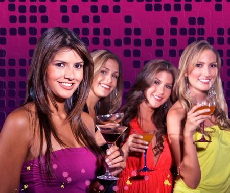 Group of girls on a night out having cocktails