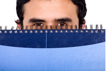 student peeping over a blue notebook isolated over a white background