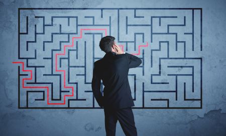 Businessman finding the solution of a maze