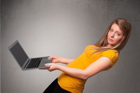 Pretty young woman holding modern laptot