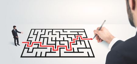 Business man looking at hand drawing solution, maze solution concept