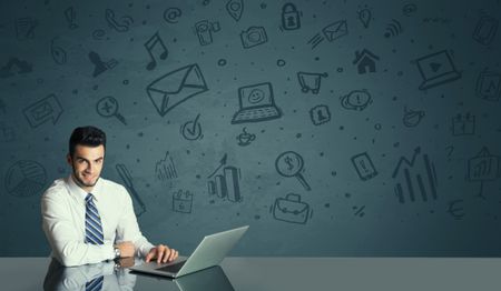 Successful businessman with all kind of media icons in background