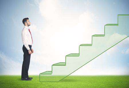 Business person stepping up a hand drawn staircase in the nature