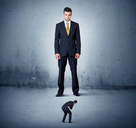 Angry huge business man lokking at small coworker guy concept on background