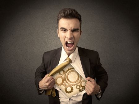 Businessman tearing shirt off and machine cog wheel shows on his chest concept on background