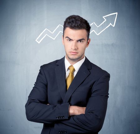 A handsome sales guy standing in front of a blue urban concrete wall with illustration of white graph chart arrows cocncept
