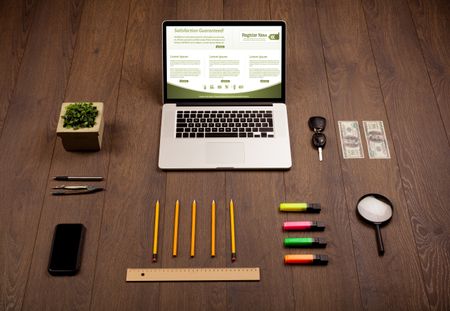 Business wooden table with notebook computer and office accessories