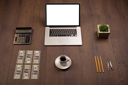 Business wooden desk with office supplies and modern laptop white background