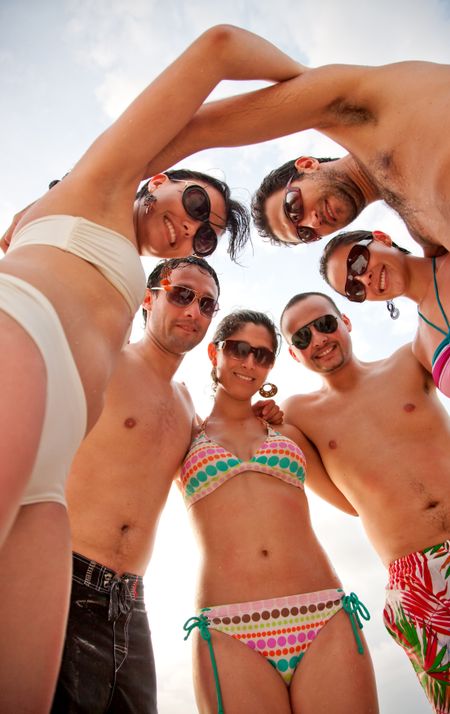 Group of friends in a circle at the beach