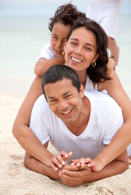 Beautiful family portrait at the beach smiling