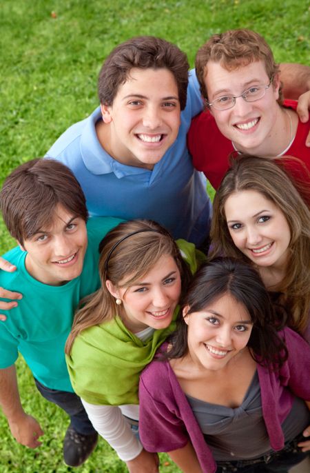 Happy group of smiley friends outdoors at the park