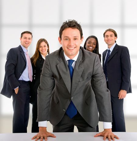 Business man with a group behind him at an office