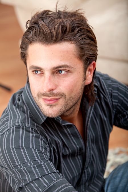 Portrait of a handsome man sitting on the floor