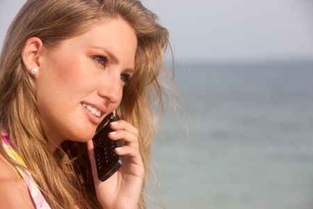 woman at the beach talking on the phone