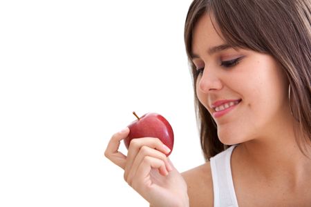 Woman looking at an apple isolated over white