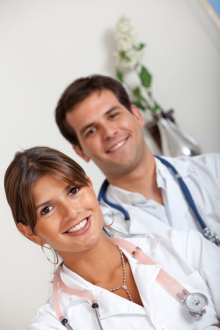 Portrait of a couple of doctors smiling indoors