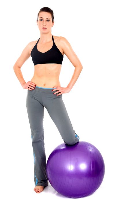 girl doing pilates with a purple ball - over a white background