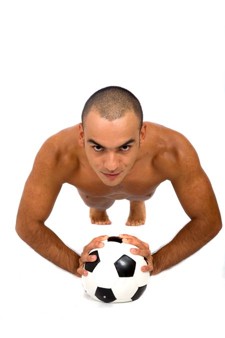 male athlete doing pushups on a soccer ball over a white background