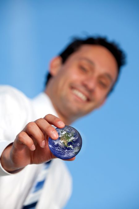 Business man holding the world in his hands