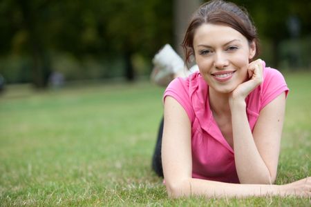 Woman lying down outdoors on the grass