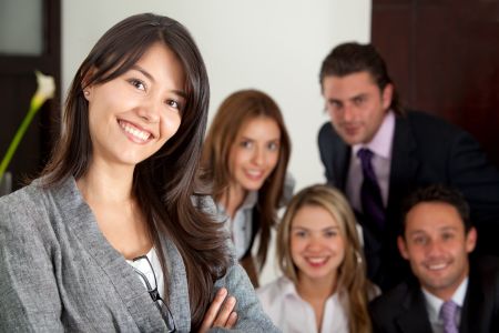 Smiley business woman in an office with her team