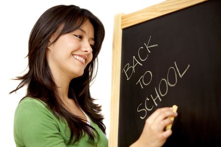 Woman writing 'back to school' in a chalkboard isolated