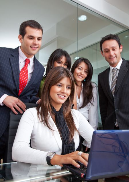 Group of business people in an office with a laptop