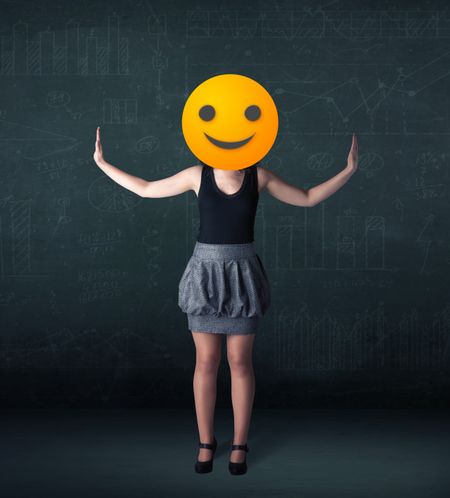 Funny businesswoman wears yellow smiley face