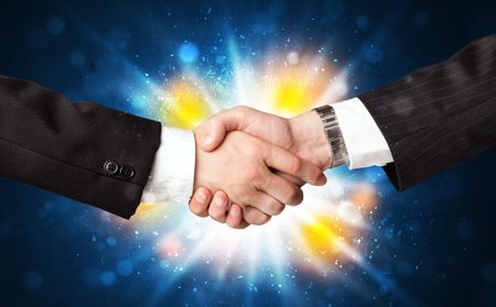 Two business men shaking hands with a successes agreement with explosion