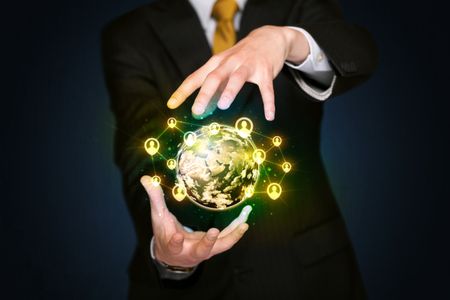 Businessman holding a shining globe with social media connection