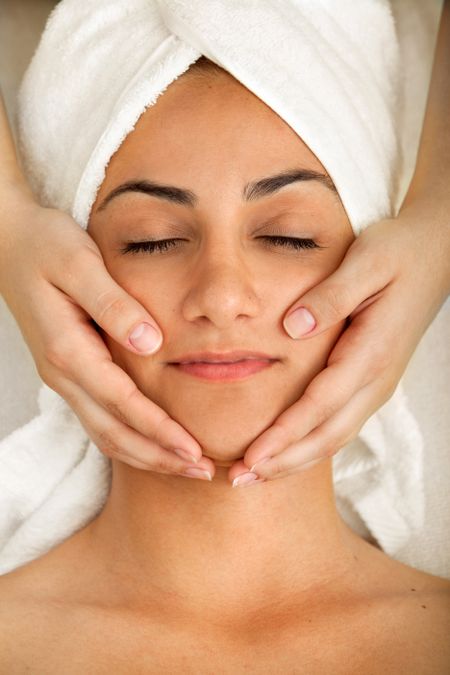 Woman at a spa getting a facial treatment