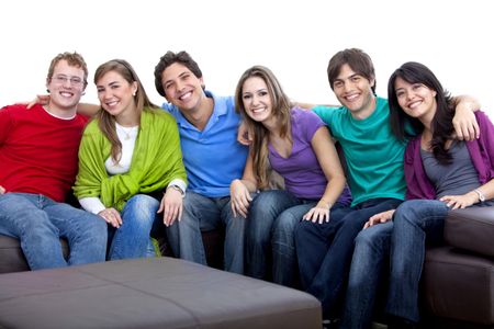 Happy group of young people sitting on the couch isolated