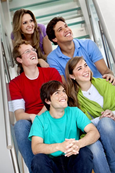 Smiley group of beautiful young people on the stairs