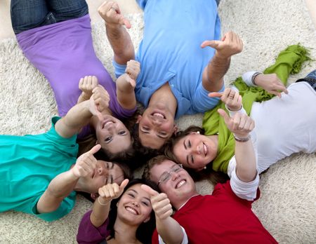 Group of people on the floor with thumbs up