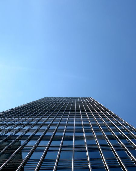 Low-angle image of a skyscraper building reaching the sky