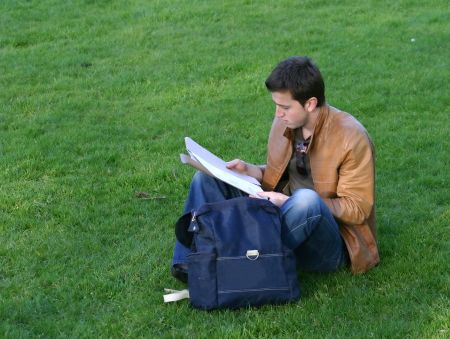 casual student doing some revision in the park
