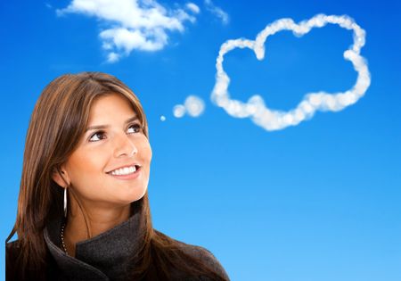 Thoughtful business woman with a blue sky on the background