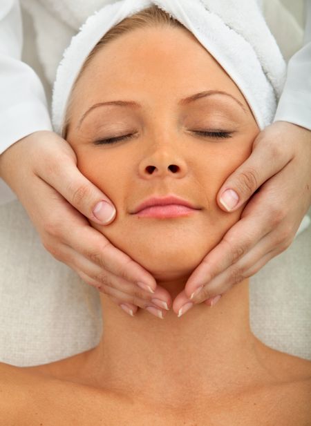 Woman at a spa having a massage in her face