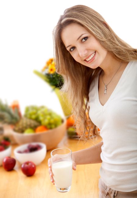 Healthy eating woman with milk and fruits smiling isolated