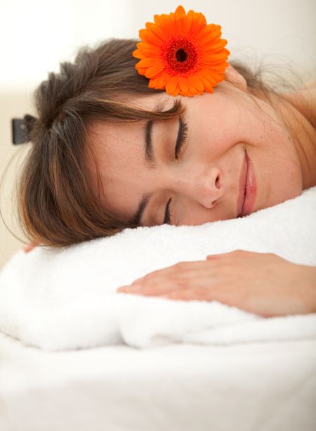 Beauty portrait of a sleeping woman with a flower