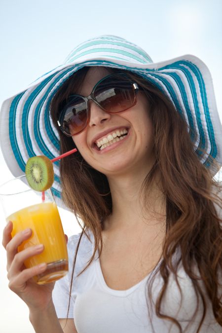Summer woman with a hat and a drink outdoors