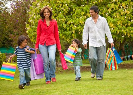 Beautiful happy family with shopping bags outdoors