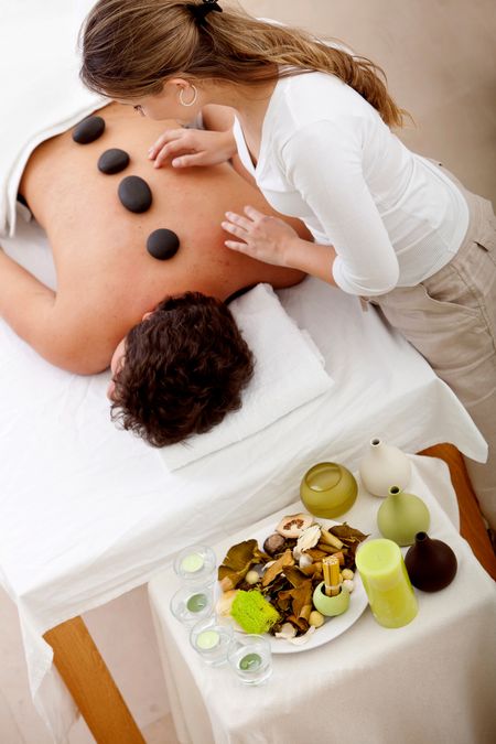 Man at a spa getting a hot stones massage