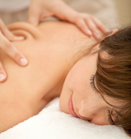 Beautiful woman having a massage on her back