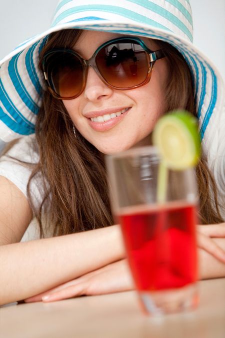Happy woman with a hat and a drink