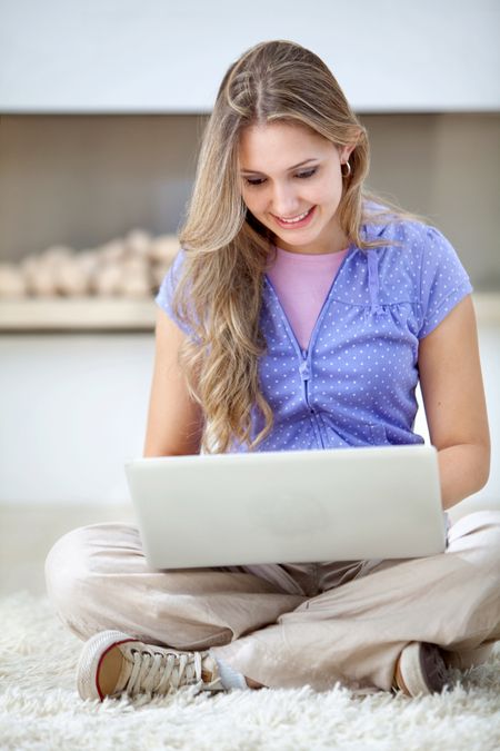 Beautiful casual woman with a laptop and smiling