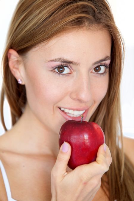 Beautiful woman portrait with a red apple isolated