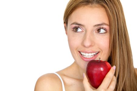 Woman eating a red apple looking up isolated